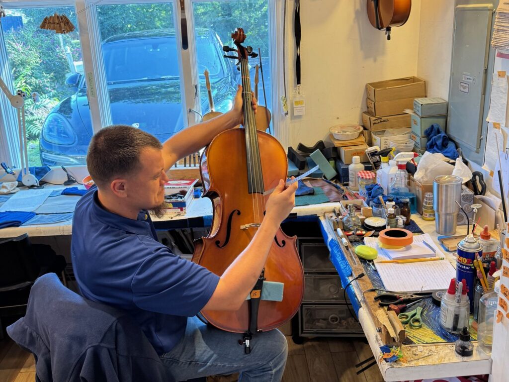 One of our luthiers setting up a cello at the bench in Norwalk