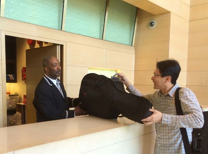 Handing a rented instrument to the doorman at a Manhattan building