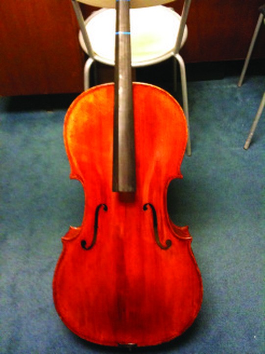 The same cello after repair, with the crack closed and the top refinished