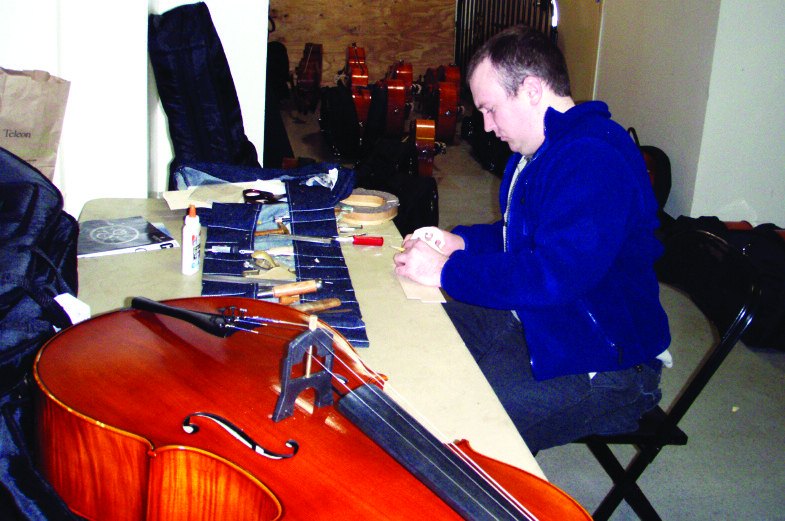 One of our luthiers working on a cello backstage at Carnegie Hall before a concert